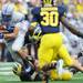 Air Force tight end Marcus Hendricks is brought down by Michigan linebacker Desmond Morgan during the fourth quarter at Michigan Stadium on Saturday. Melanie Maxwell I AnnArbor.com